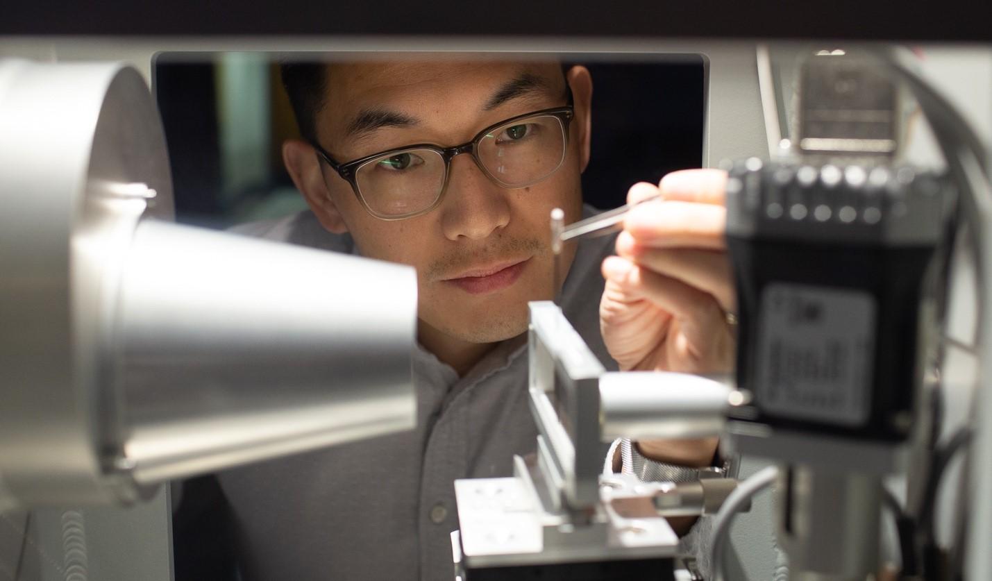 Xiaodan Gu inspecting specimen with tweezers